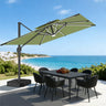 Patioslife 10x13 ft sage green cantilever umbrella with LED lights over outdoor dining table by ocean view patio