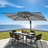 Patioslife 10x13 ft tan cantilever umbrella shading patio dining table on ocean view backyard