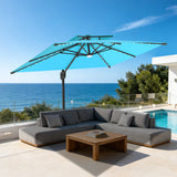 Patioslife 10x13 ft turquoise cantilever umbrella with LED lights over gray sectional sofa and wooden coffee table by pool and ocean
