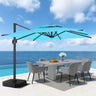 Patioslife 10x13 ft turquoise cantilever umbrella over white outdoor dining set beside ocean view pool
